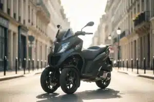 Scooter à trois roues stationné dans une rue urbaine ensoleillée, vue de trois quarts avant